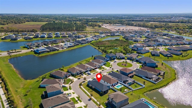 drone / aerial view featuring a residential view and a water view