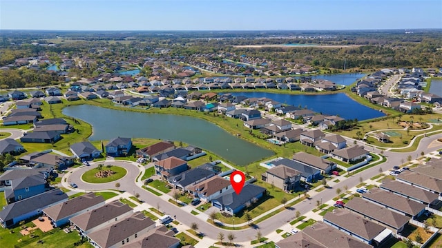 drone / aerial view featuring a residential view and a water view