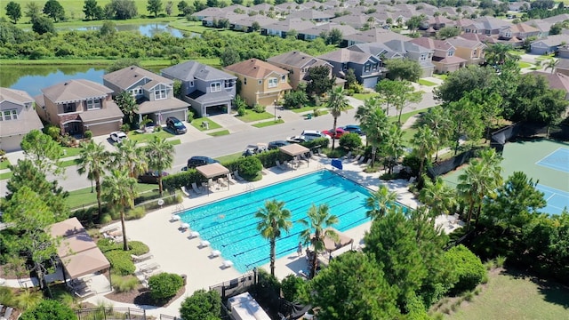 drone / aerial view featuring a residential view and a water view