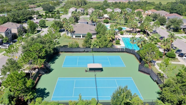 view of sport court with fence and a residential view