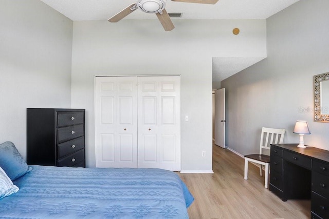 bedroom featuring a ceiling fan, baseboards, visible vents, light wood finished floors, and a closet