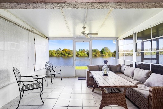 sunroom / solarium featuring a water view and a ceiling fan