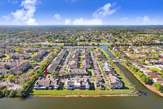 drone / aerial view with a residential view and a water view