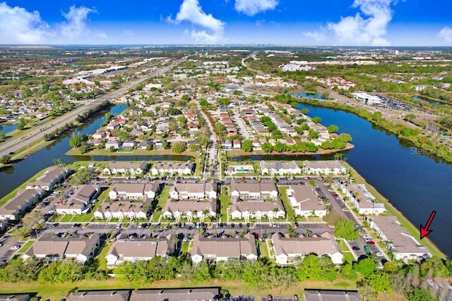 drone / aerial view featuring a residential view and a water view