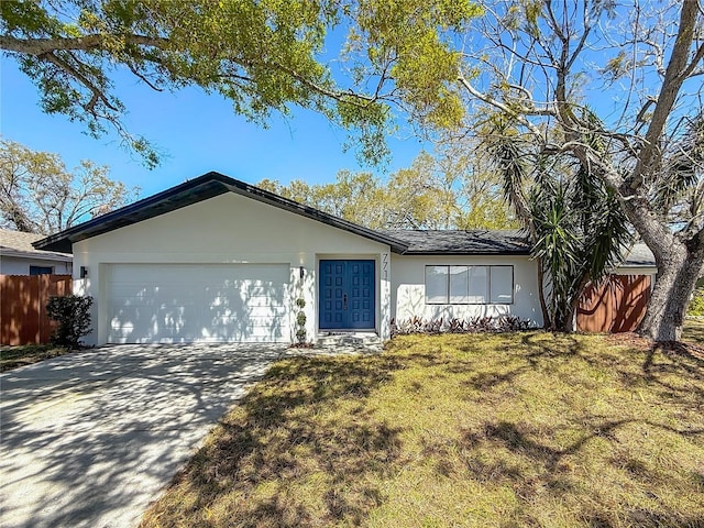 single story home featuring fence, concrete driveway, a front yard, stucco siding, and an attached garage