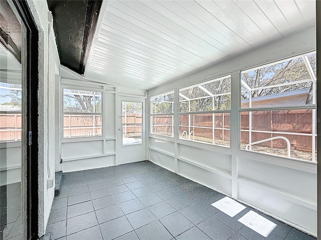 unfurnished sunroom featuring wood ceiling and vaulted ceiling