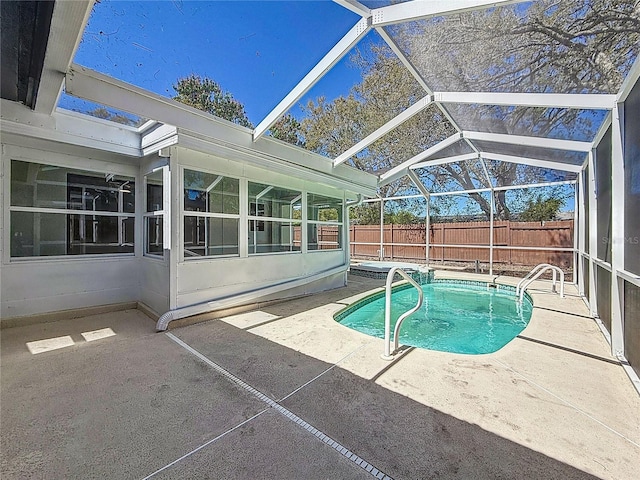 view of swimming pool with a fenced in pool, a patio, glass enclosure, and fence