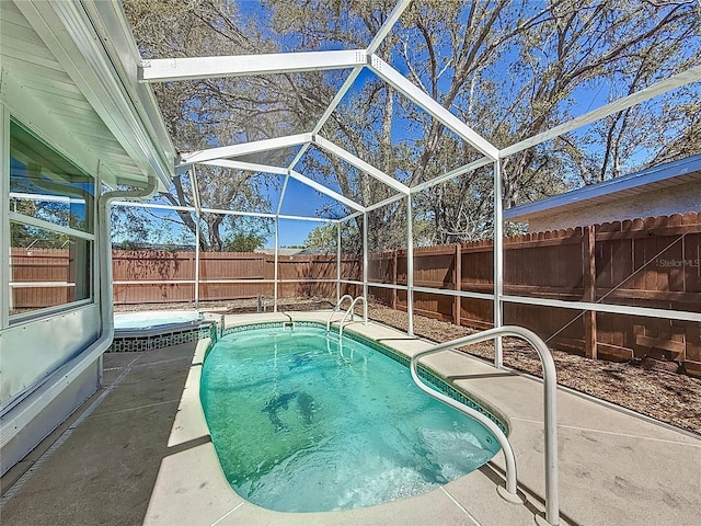 view of pool with a lanai, a fenced in pool, a patio, and a fenced backyard