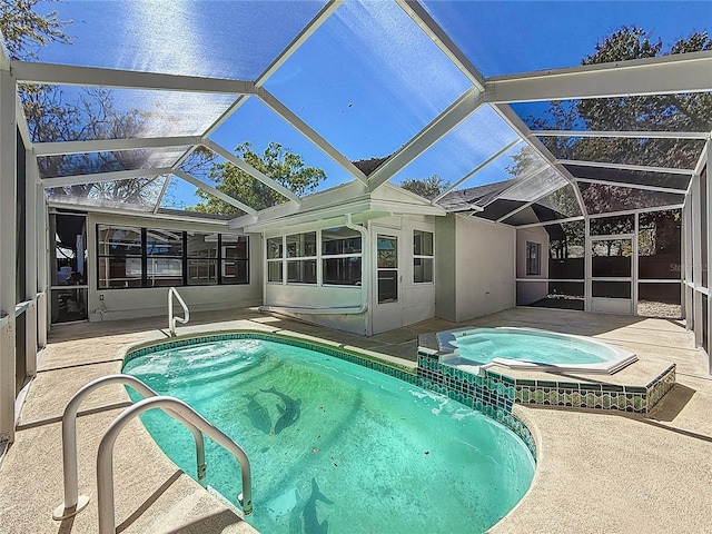 view of pool featuring glass enclosure, a patio, and a pool with connected hot tub