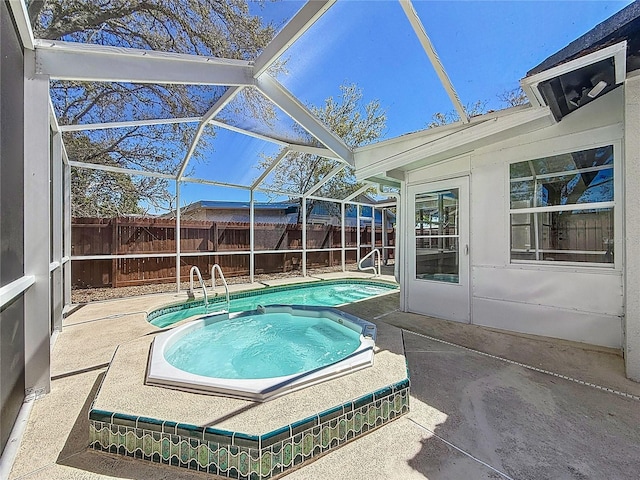 view of swimming pool with a patio area, an in ground hot tub, a lanai, and fence