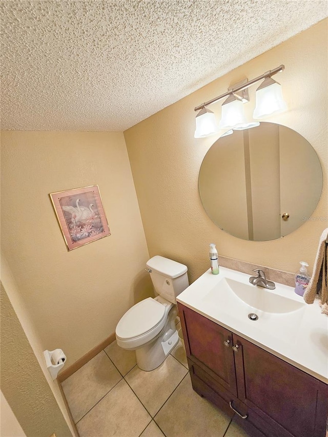 half bath featuring tile patterned floors, toilet, a textured ceiling, and vanity