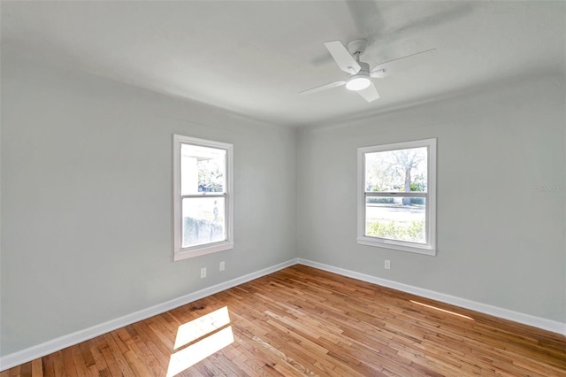 unfurnished room with plenty of natural light, light wood-style flooring, baseboards, and ceiling fan