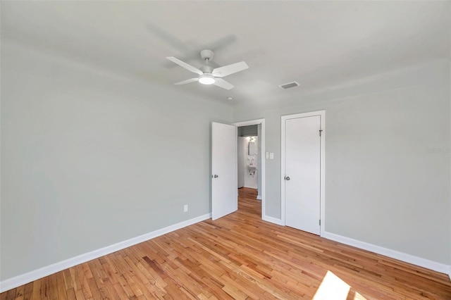 unfurnished bedroom featuring visible vents, ceiling fan, baseboards, and light wood-style floors