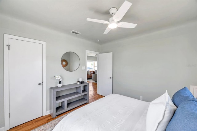 bedroom featuring visible vents, ceiling fan, and wood finished floors