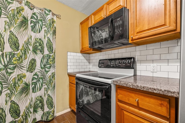 kitchen with electric range, tasteful backsplash, a textured ceiling, black microwave, and dark wood-style flooring