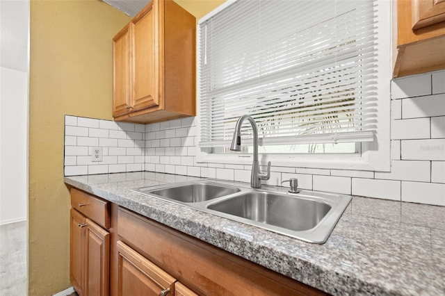 kitchen with a sink and tasteful backsplash