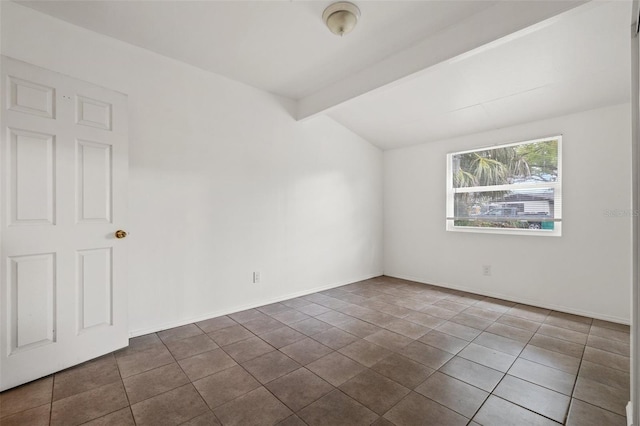 empty room featuring tile patterned flooring, lofted ceiling with beams, and baseboards