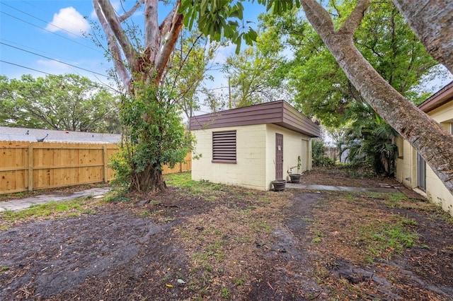 view of yard with an outdoor structure and fence private yard