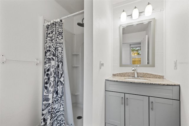 bathroom featuring vanity and a shower stall