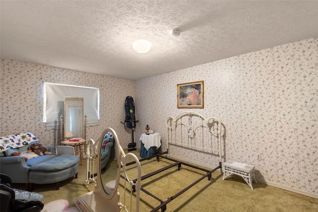 bedroom with a textured ceiling, baseboards, carpet, and wallpapered walls