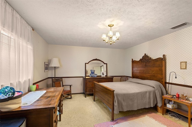 bedroom with visible vents, light carpet, a textured ceiling, an inviting chandelier, and wallpapered walls