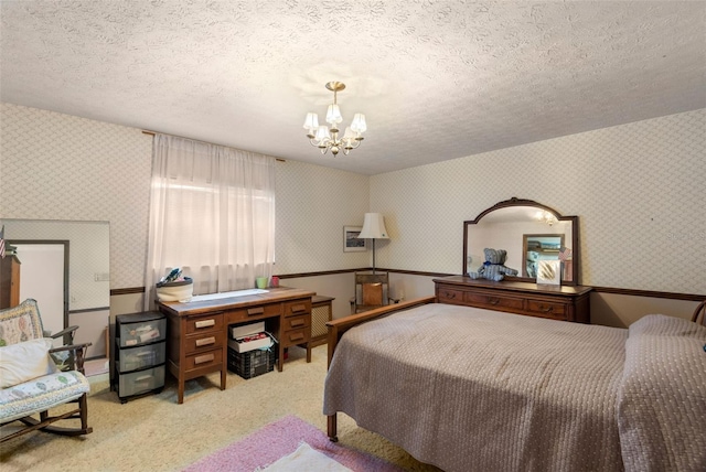 bedroom featuring a chandelier, a textured ceiling, wallpapered walls, and carpet