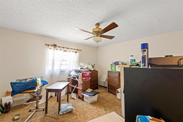 office with carpet, a ceiling fan, and a textured ceiling