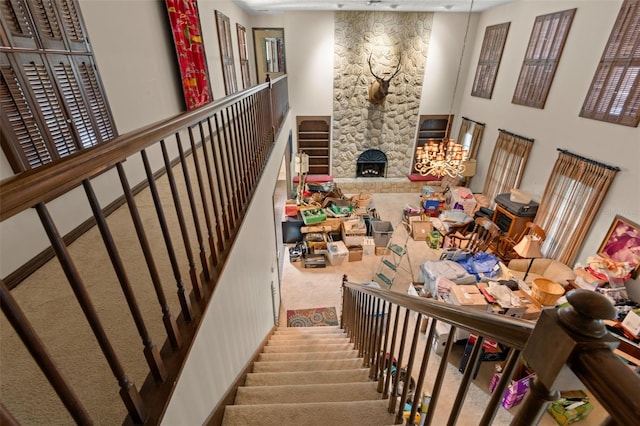 stairs featuring a fireplace and carpet