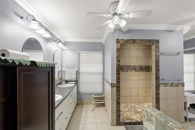 full bath featuring a sink, a walk in shower, a textured ceiling, crown molding, and tile patterned floors