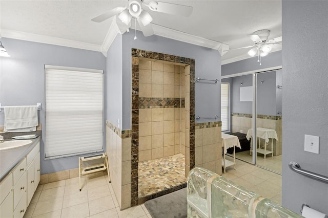 full bath featuring crown molding, walk in shower, tile patterned floors, vanity, and a ceiling fan