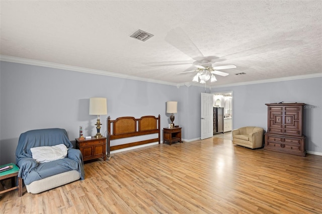 living area featuring visible vents, light wood-style flooring, ornamental molding, a textured ceiling, and baseboards