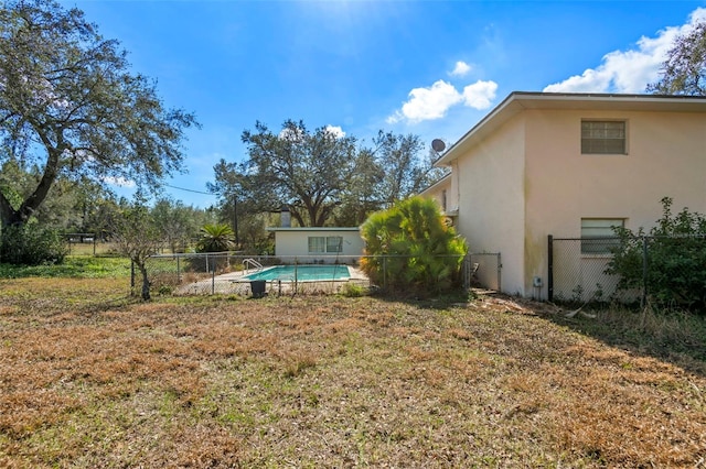 view of yard featuring a fenced in pool and fence