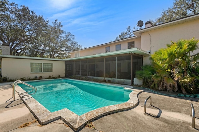 outdoor pool featuring a patio area and a sunroom