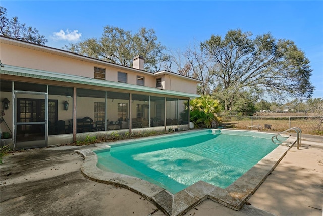 view of swimming pool featuring a fenced in pool, a sunroom, a patio, and fence