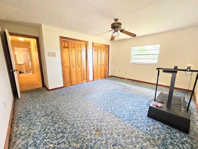 11327 Carter Grove Ln, Thonotosassa, FL 33592 - unfurnished bedroom with carpet, two closets, a textured ceiling, and a ceiling fan