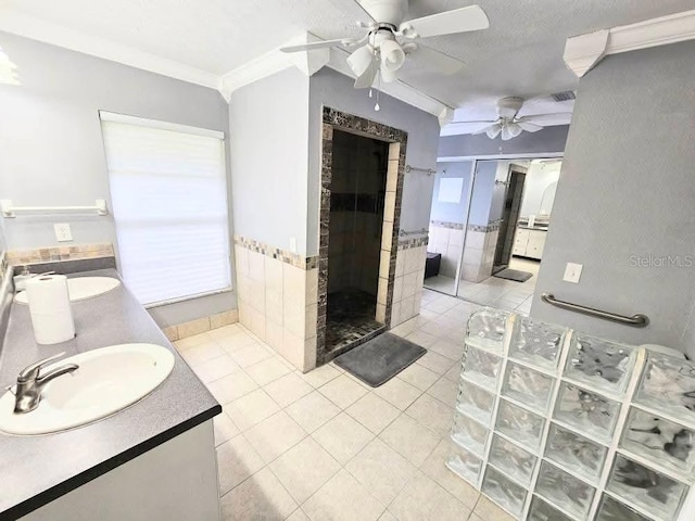 11327 Carter Grove Ln, Thonotosassa, FL 33592 - full bathroom with tile patterned flooring, a ceiling fan, a stall shower, a wainscoted wall, and tile walls