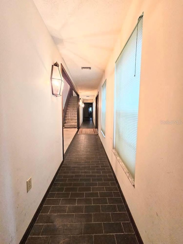 11327 Carter Grove Ln, Thonotosassa, FL 33592 - hallway featuring brick floors and stairway