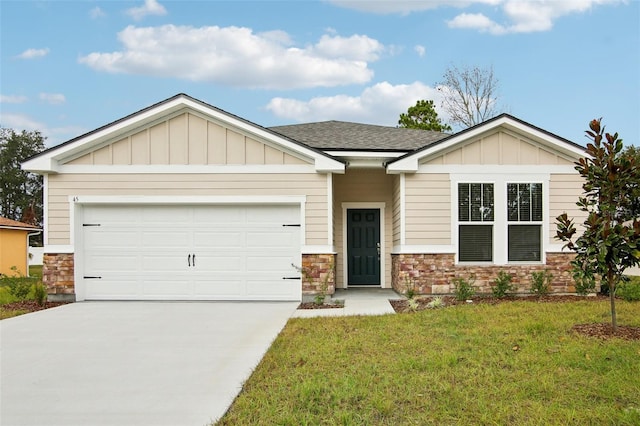 view of front of house with driveway, a front lawn, stone siding, board and batten siding, and an attached garage