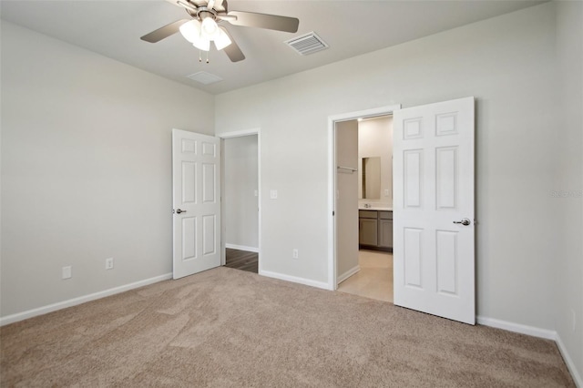 45 Perkins Ln, Palm Coast, FL 32164 - unfurnished bedroom with baseboards, visible vents, ensuite bathroom, and light carpet