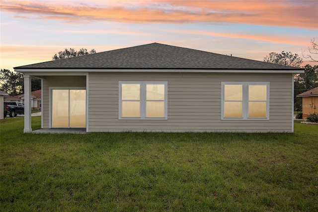 45 Perkins Ln, Palm Coast, FL 32164 - rear view of house featuring a lawn and roof with shingles