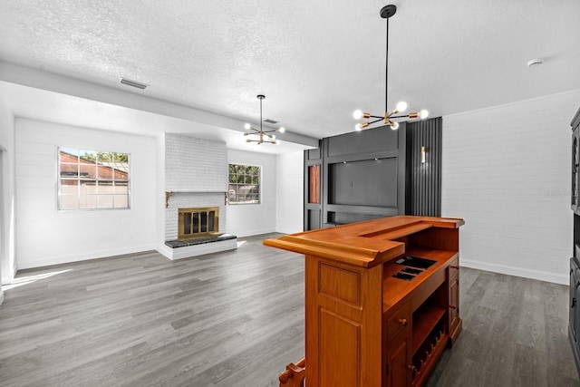 kitchen featuring dark wood finished floors, plenty of natural light, visible vents, and a chandelier