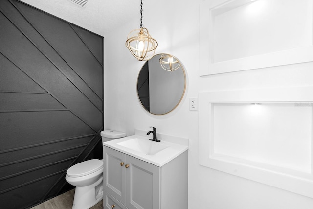 bathroom featuring toilet and vanity