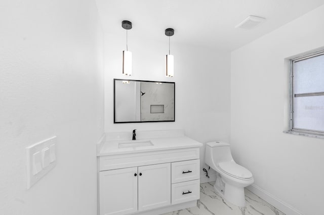 bathroom with baseboards, marble finish floor, vanity, and toilet