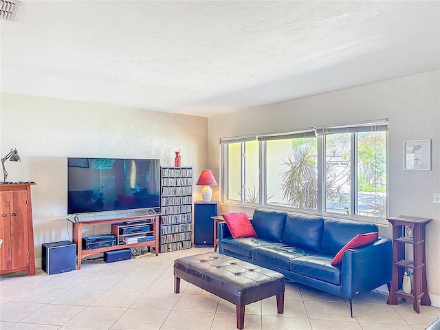 tiled living area featuring visible vents and a textured ceiling