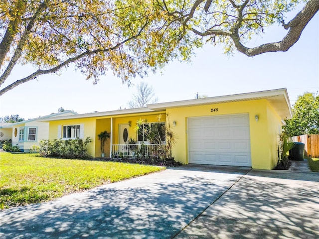 single story home featuring stucco siding, an attached garage, driveway, and a front yard