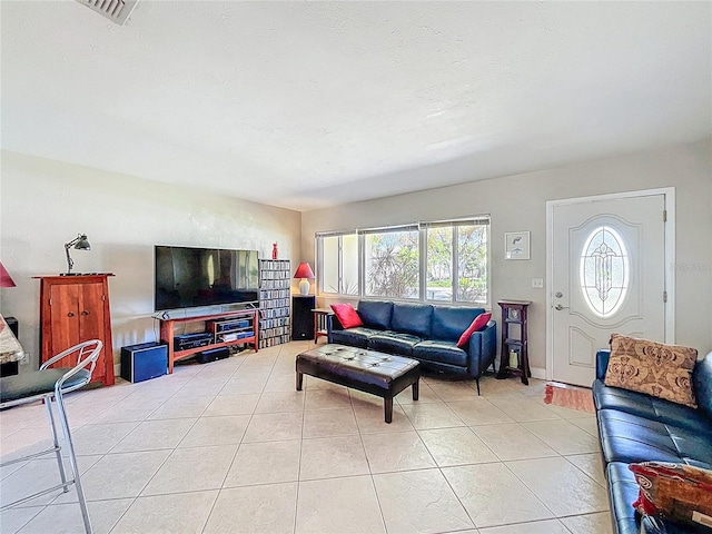 living room with light tile patterned floors and visible vents