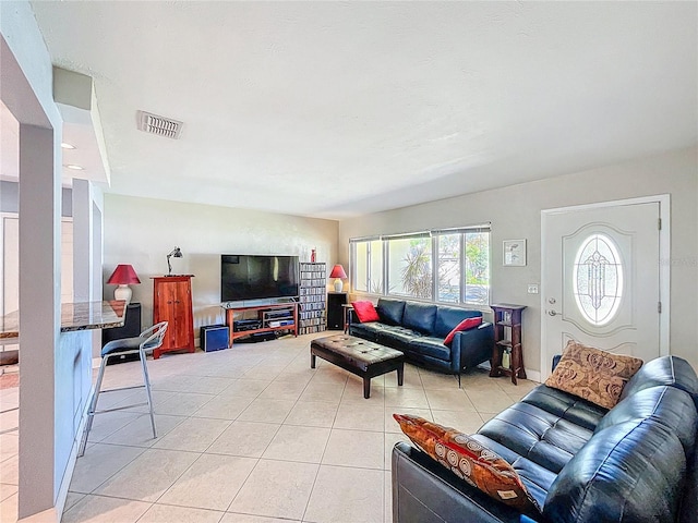 living room with light tile patterned flooring and visible vents