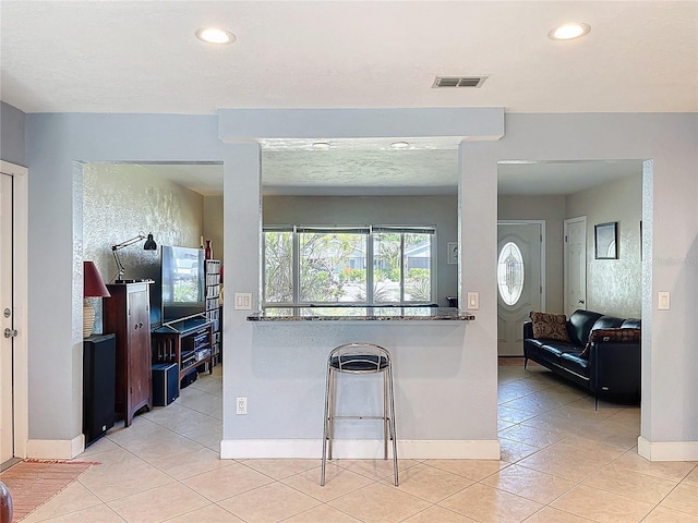 kitchen featuring light tile patterned flooring, visible vents, recessed lighting, and baseboards