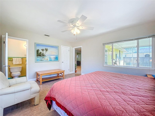 bedroom with visible vents, baseboards, ensuite bath, and ceiling fan