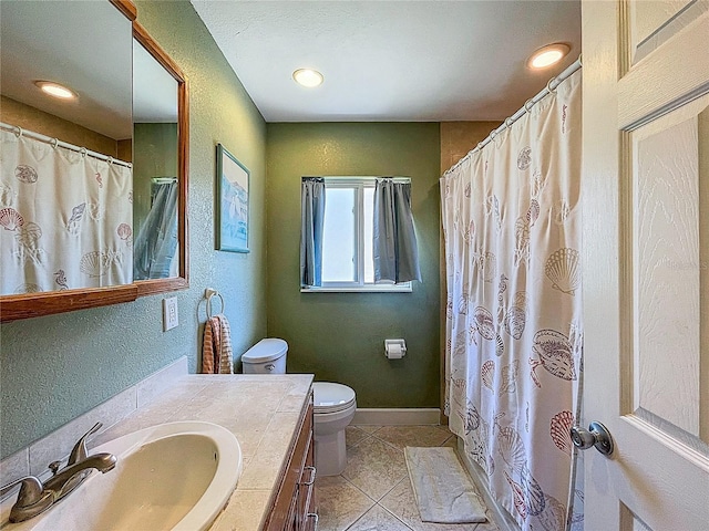 full bathroom featuring vanity, baseboards, tile patterned flooring, toilet, and a textured wall